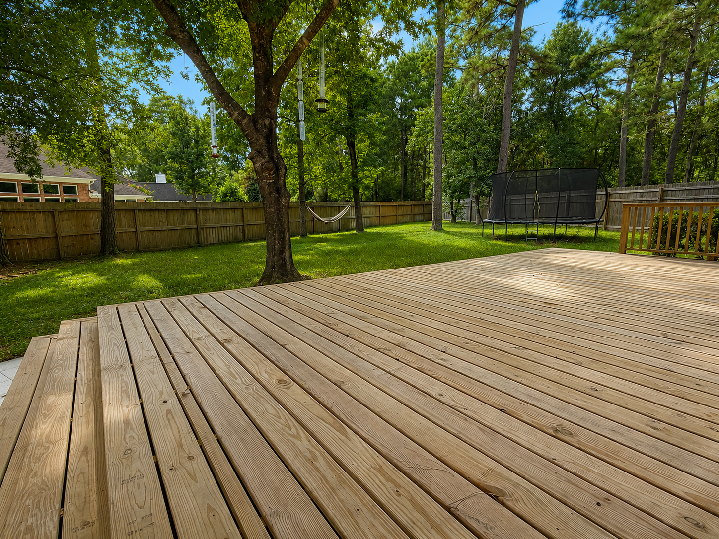 A charming exterior perspective captures the home's inviting curb appeal, peaceful setting, lawn, and a brand-new oversized deck built in 2025. A charming exterior perspective captures the home's inviting curb appeal, peaceful setting, lawn, and a brand-new oversized deck built in 2025.